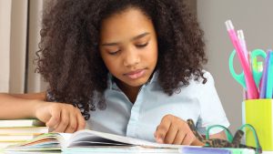 african american student gets math help and reading help in Fit Homeschool in St. Louis with her tutor at Fit Learning 