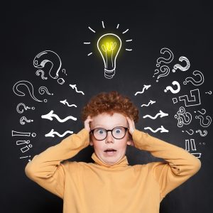 A shocked child holds both sides of their head as a lightbulb illustration flashes on above their head. They could represent a child having a lightbulb moment at the Fit Learning Lab. Contact us today to learn about Fit Tutoring, a private tutor, and ADHD tutoring in Saint Louis, MO!