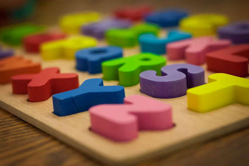 Photo of puzzle with rainbow ABCs. If you are looking for dyslexia help in St. Louis, MO then we are here to help. We can also help children with ADHD in St. Louis 63005.