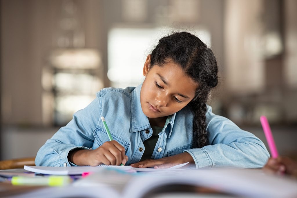 Girl in denim jacket writing in a notebook. Have you been wondering "what is dyslexia" and need some answers? Our summer Camp program can help get you started with answers and set you up with a dyslexia tutor in Creve Coeur, MO 63141.