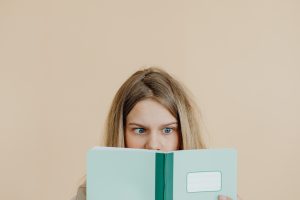 middle school student looks confused and overwhelmed while reading a school book, something Fit Learning can help with