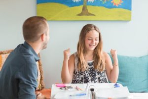 child looks excited after getting reading help in Saint Louis with Fit Reading and a reading tutor at Fit Learning St. Louis 63141